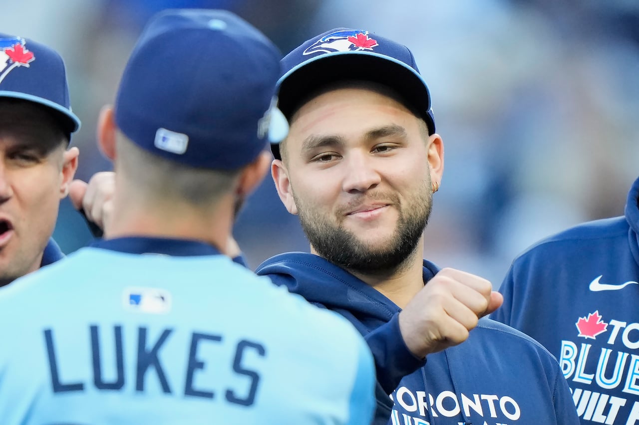 A baseball player looks toward a teammate