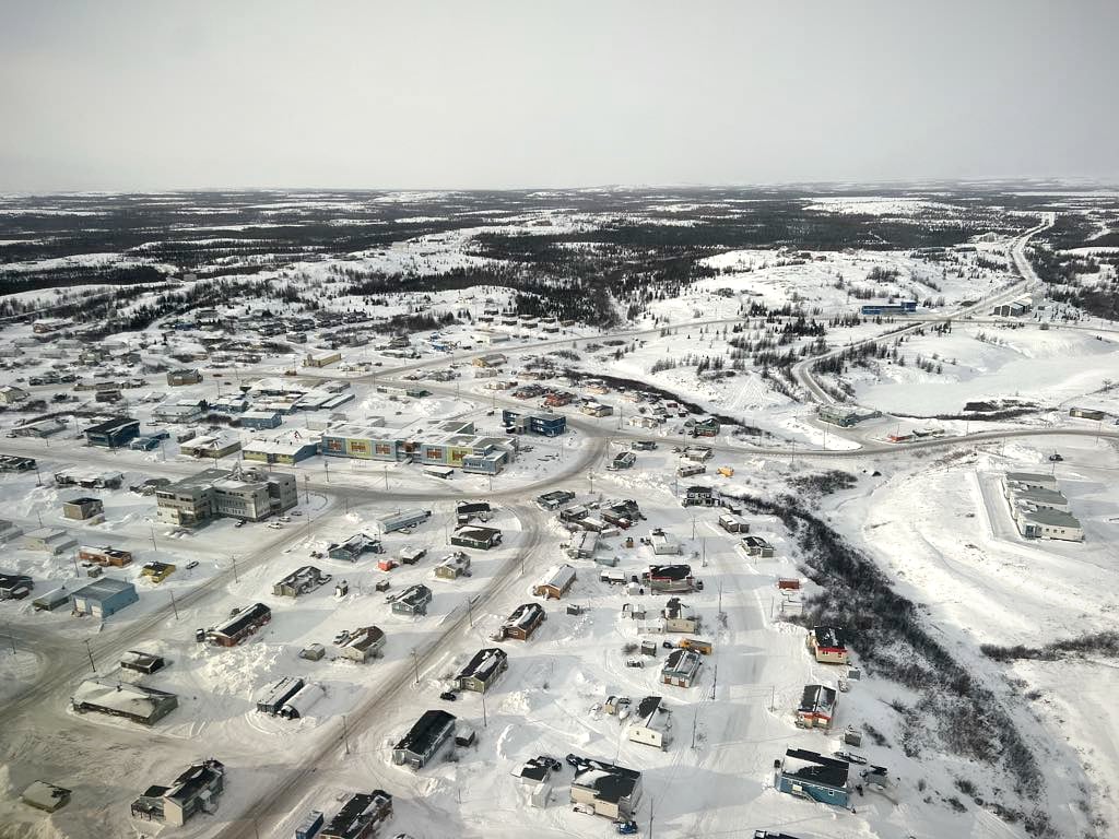 An aerial presumption    of a tiny  town, covered successful  snow