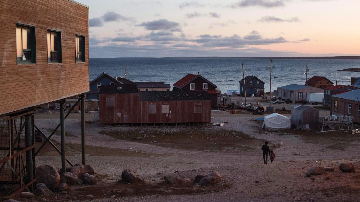 Gjoa Haven, Nunavut Adult and child walk through community in Gjoa Haven, Nunavut.
