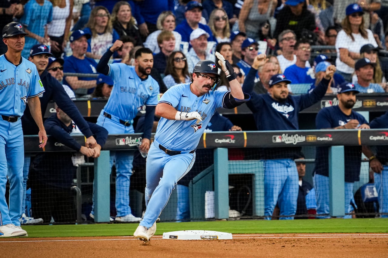 A baseball player with a mustache and glasses reaches for his helmet while running around the bases after hitting a home run.