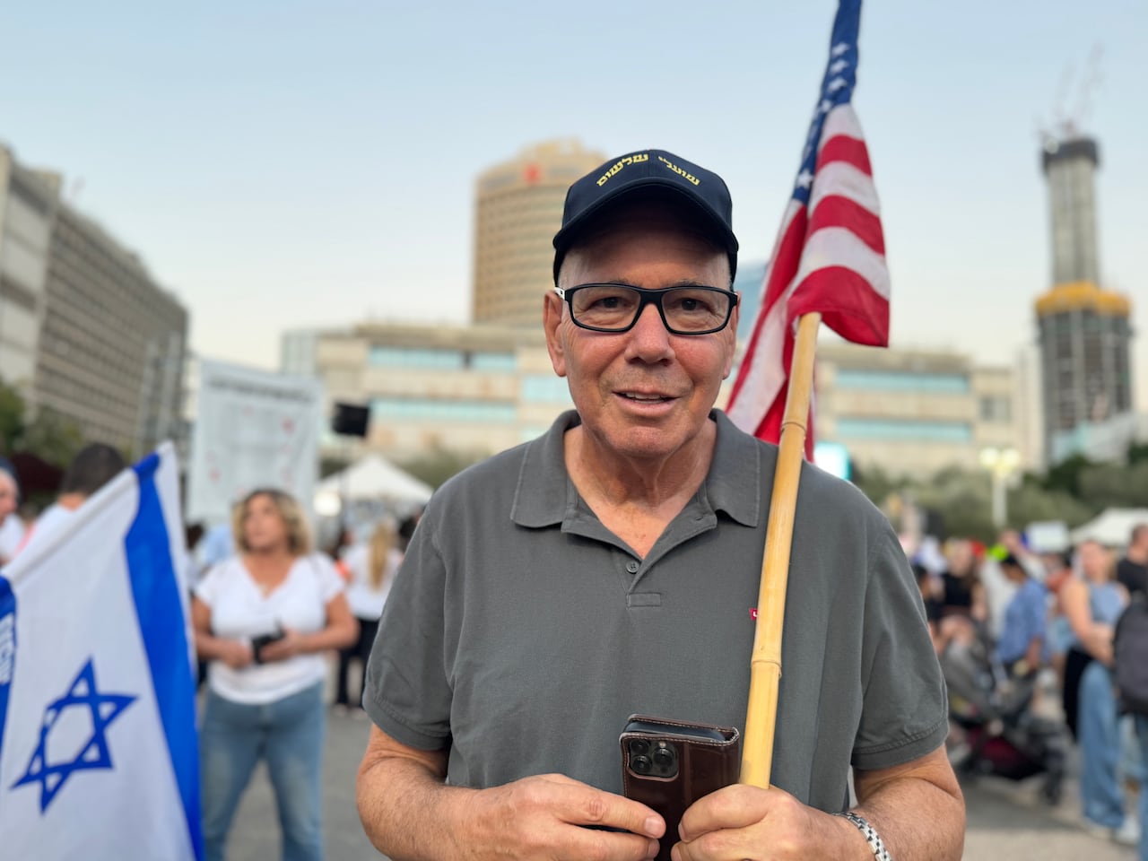 A person carries a flag while posing for a photograph.