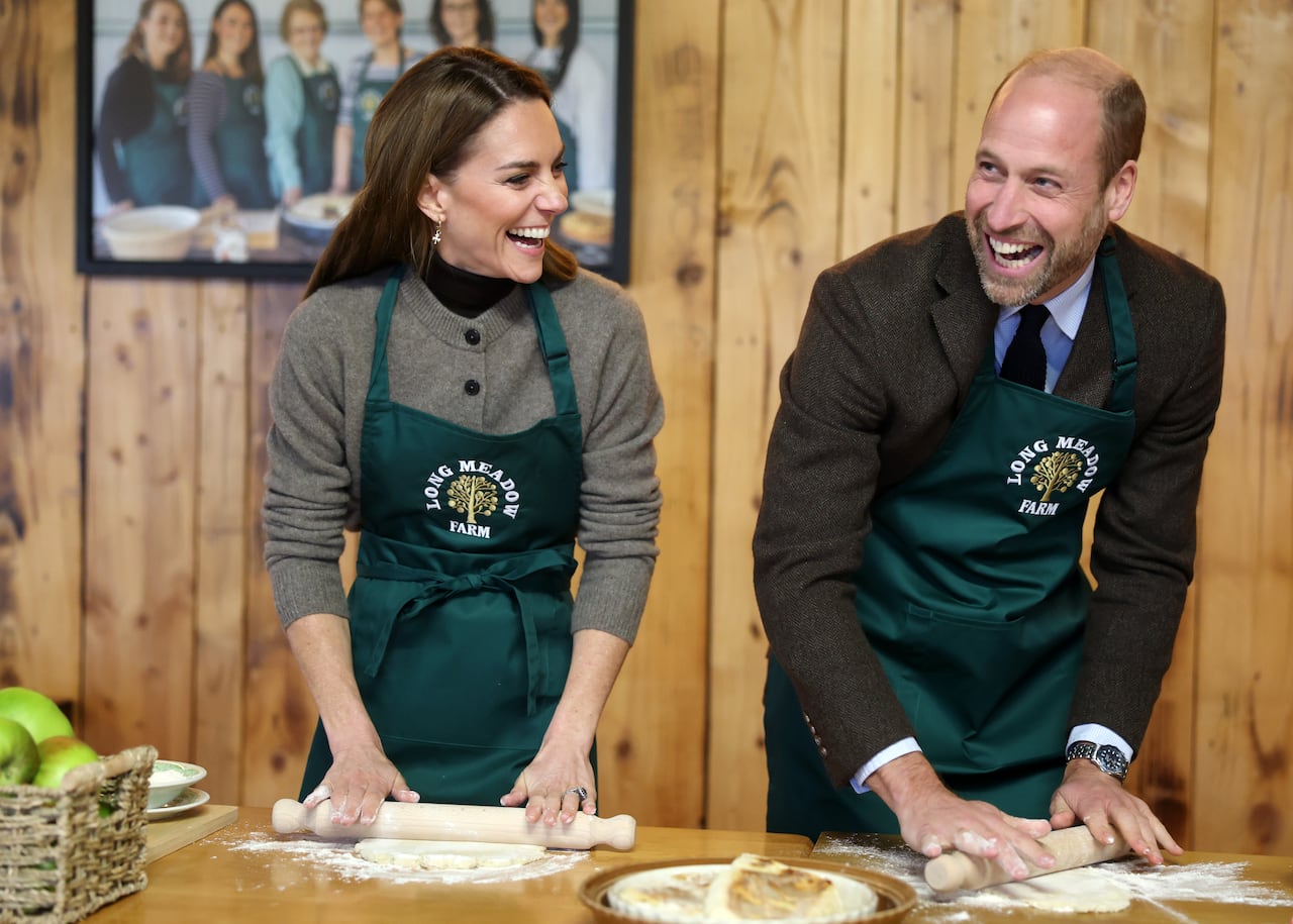 Two people roll dough.