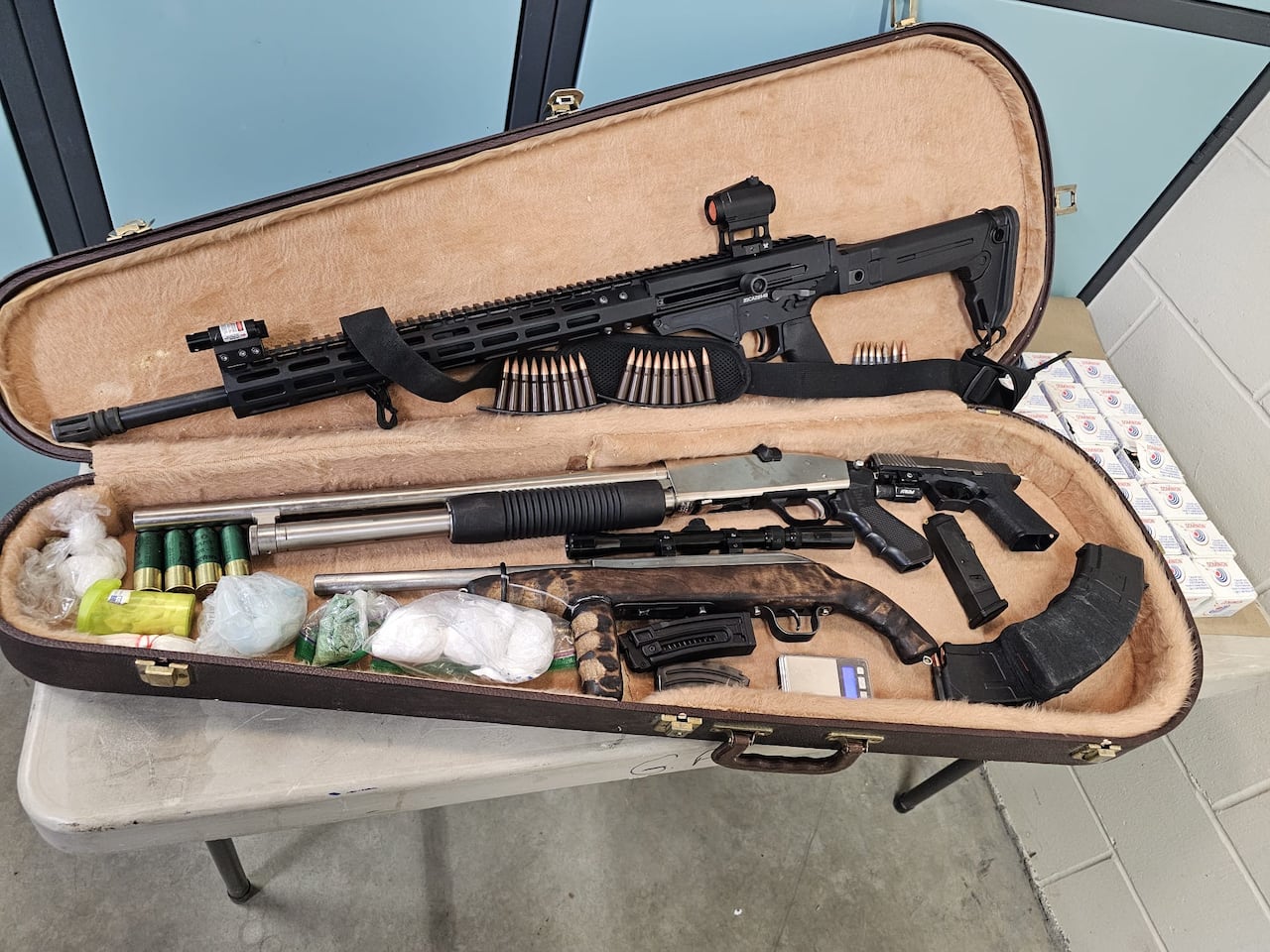 A guitar case filled with guns and drugs