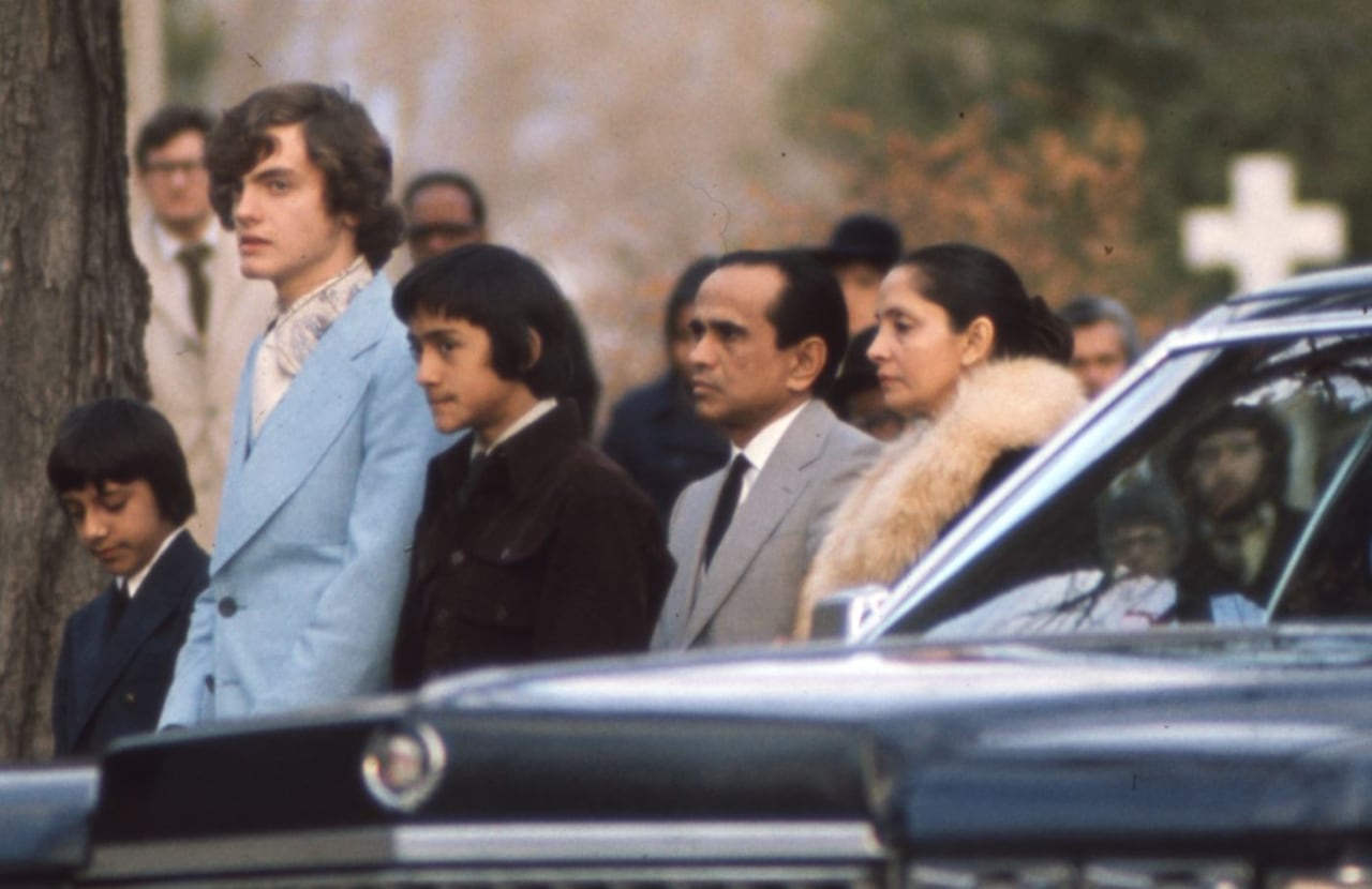 Kim Rabot's family members, alongside her boyfriend at the time, gather at the cemetery after her funeral on Oct. 30, 1975. Rabot's casket was a light blue colour too.