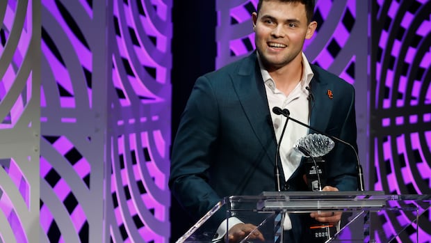 A man speaks at a podium.