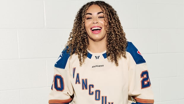 PWHL Vancouver forward Sarah Nurse wears the team's inaugural away jersey. The team will play its first game against PWHL Seattle on Nov. 21. A woman wears a hockey jersey with Vancouver printed on it.