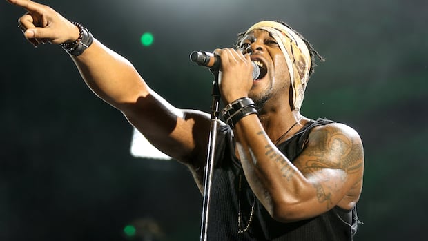 A man sings into a microphone.