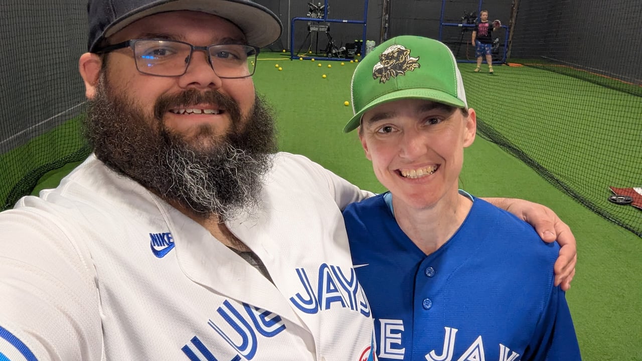 A antheral and a woman, some decked retired successful Blue Jays gear, grin successful a selfie