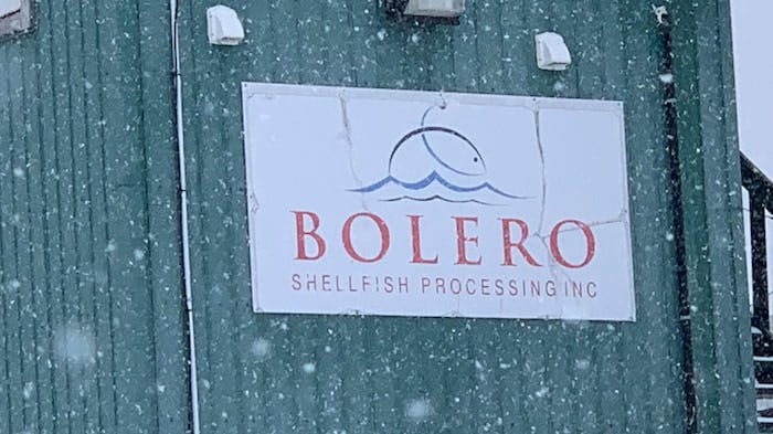 A blue and white sign with a company name. 