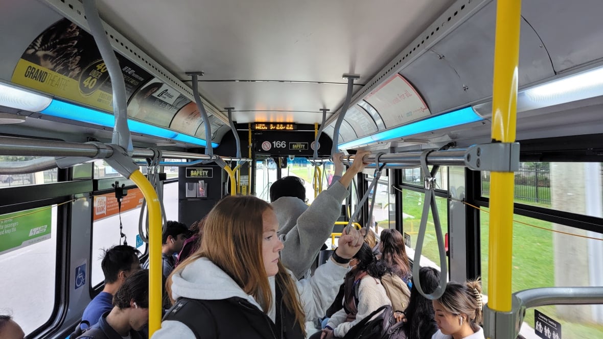 Passengers riding inside a London Transit bus.