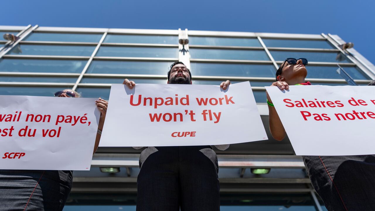 Air Canada flight attendants hold a silent protest at Montreal-Pierre Elliott Trudeau International Airport in Montreal, on Monday, Aug. 11, 2025. 