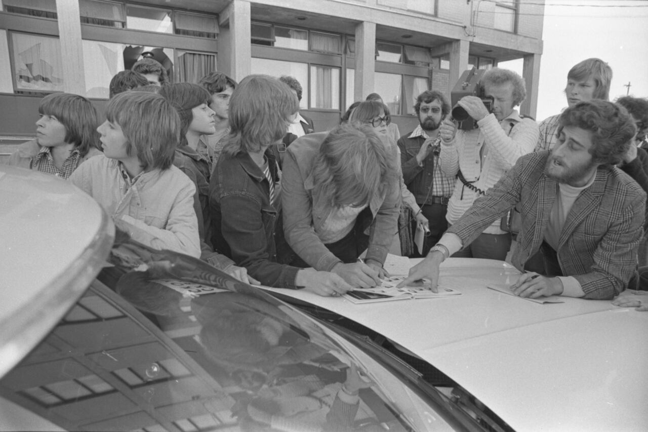 In the aftermath of the shooting at St. Pius X High School, students point out their classmates' yearbook photos to the media. The classroom window that students broke through after the shooting can be seen in the background.