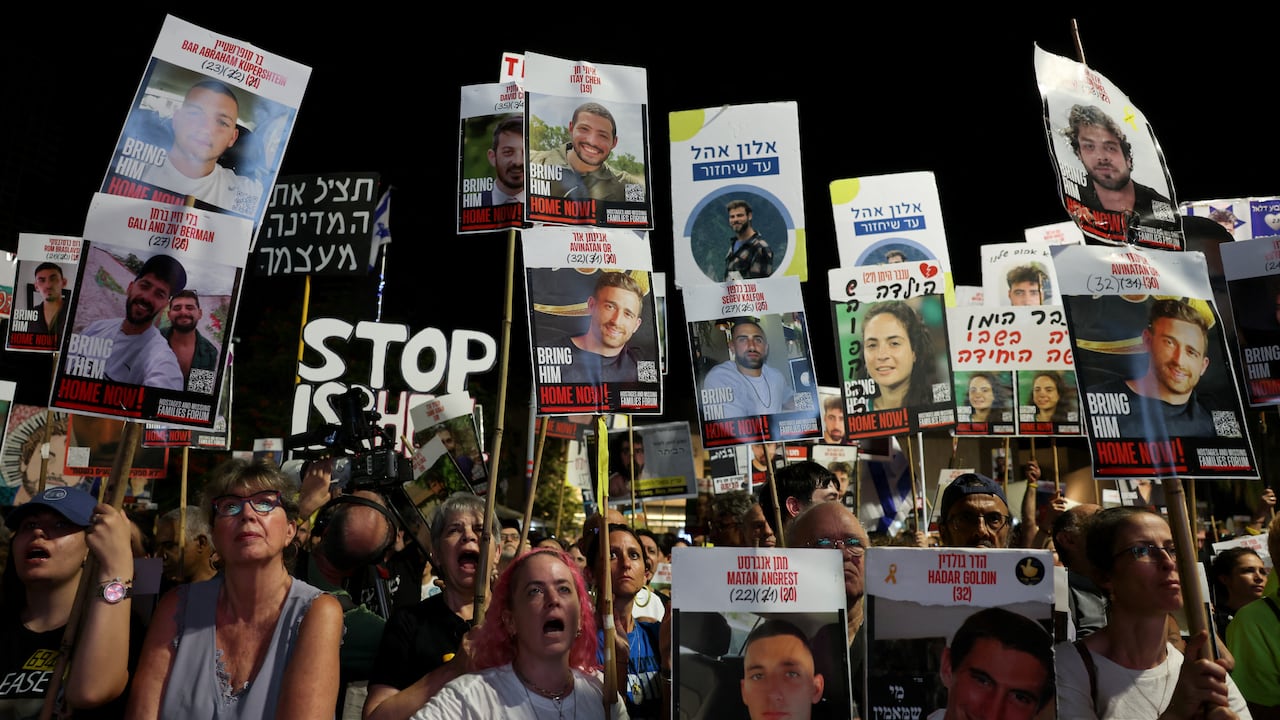 People protest at night.