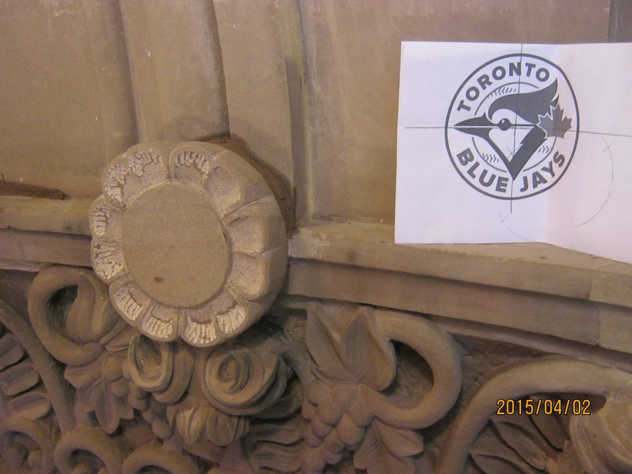 A circle of stones and a print of the Toronto Blue Jays logo.