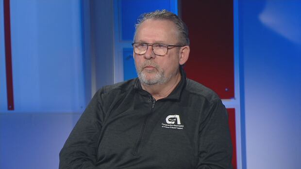 Sam Sanderson is executive director of the Construction Association of P.E.I. Man with glasses and grey hair, wearing black sweater with white logo that say Construction Association of Prince Edward Island.