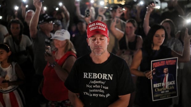 A man wearing a MAGA hat reacts alongside people gathered at the headquarters of Turning Point USA, ahead of a memorial service to be held on September 21 for slain conservative commentator Charlie Kirk, in Phoenix, Arizona, U.S., September 19, 2025.