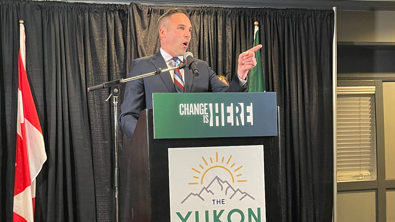 A man speaks from behind a podium.