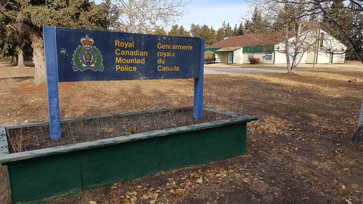 a sign of rcmp in a grassy area