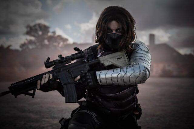 A person holding a gun with a metallic looking arm.