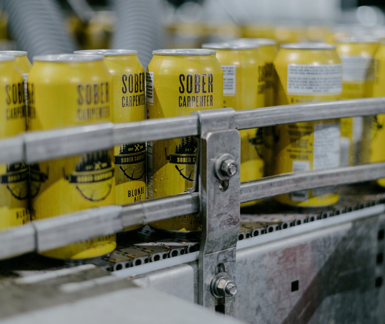 Yellow cans of a sober carpenter on a production line in a factory