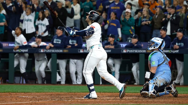 A baseball player hits a home run.