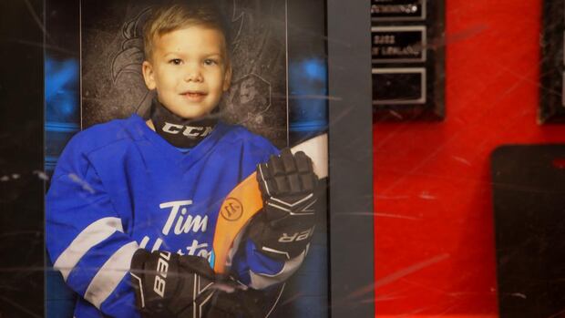 A photo of Tate Hughes in a display case at the Moncton 4-Plex. Skate for Tate grew out of a cause that captured the hearts of an entire province. Last year’s event raised more than $15,000 to help all children play the sport Tate Hughes loved so much. A photo of a a young boy wearing hockey equipment is on display.