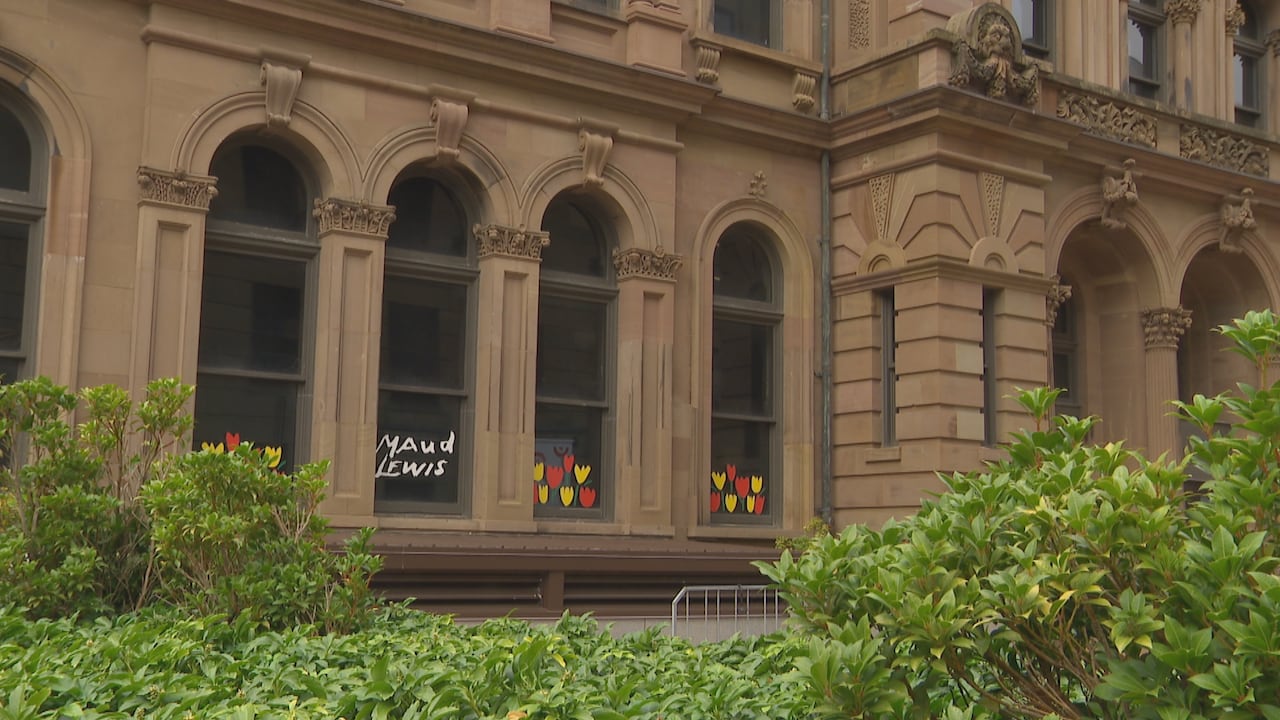 Windows of a large building with stone carvings.
