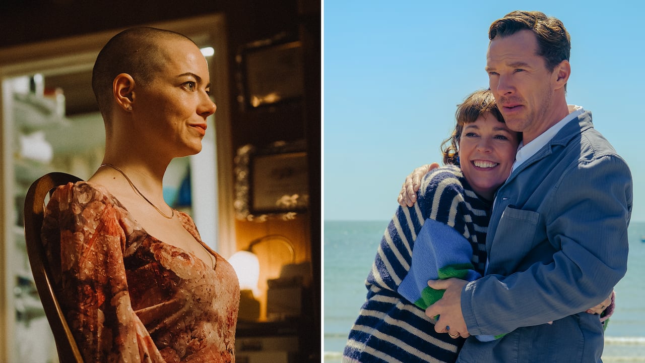 A bald, tightly smiling woman sits in a kitchen char. On the right, a man and woman embrace one another.