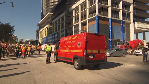 Truck with Toronto fire logo is parked in front of construction site