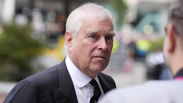 A grey-haired man in a suit. 
