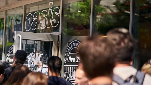 Back of people's heads in line for a store