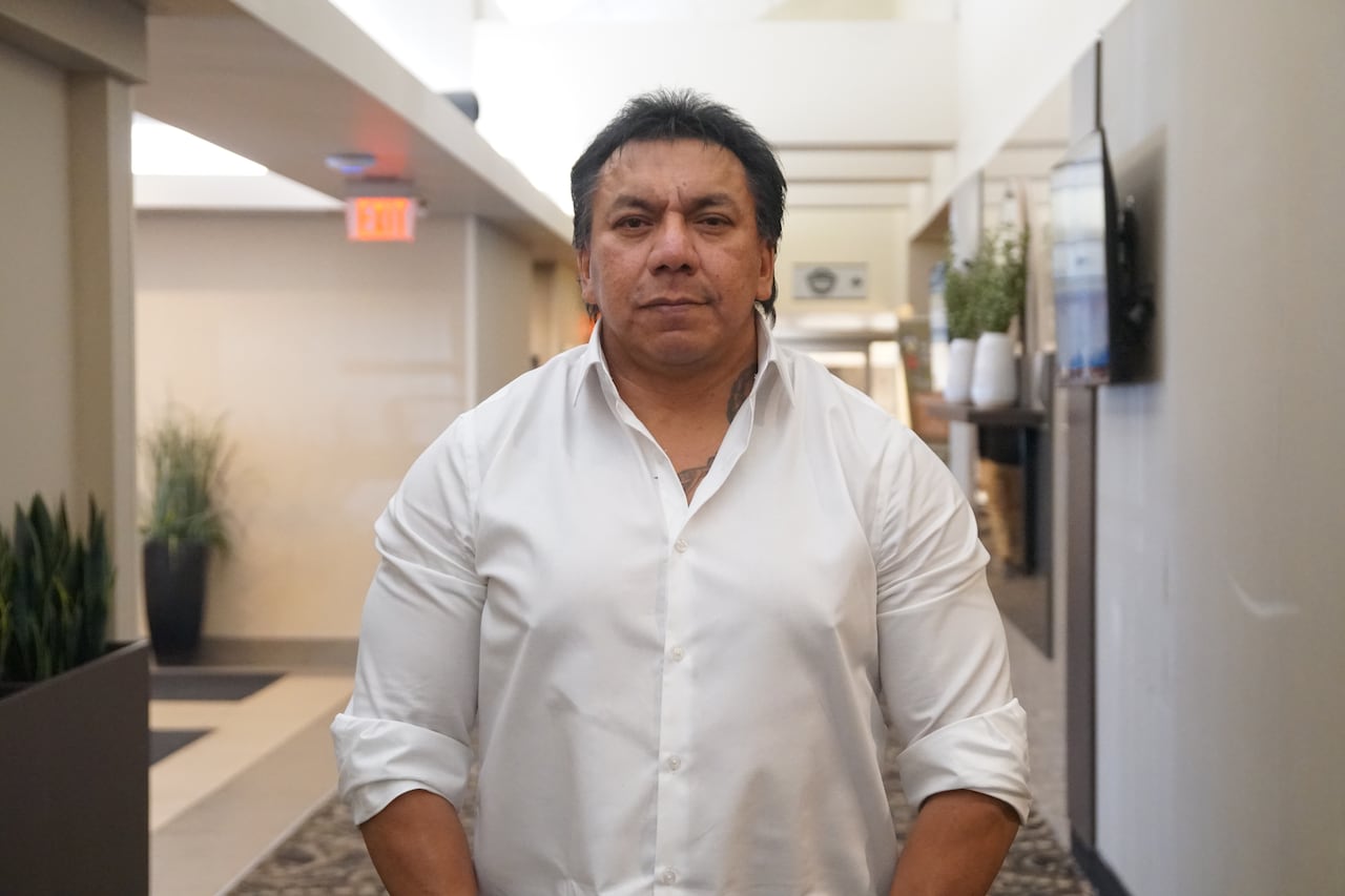 A idiosyncratic wearing a achromatic formal garment is seen lasting successful a hallway.