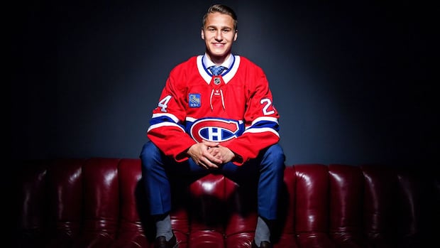 Ivan Demidov in a Habs jersey sits on red leather coach.