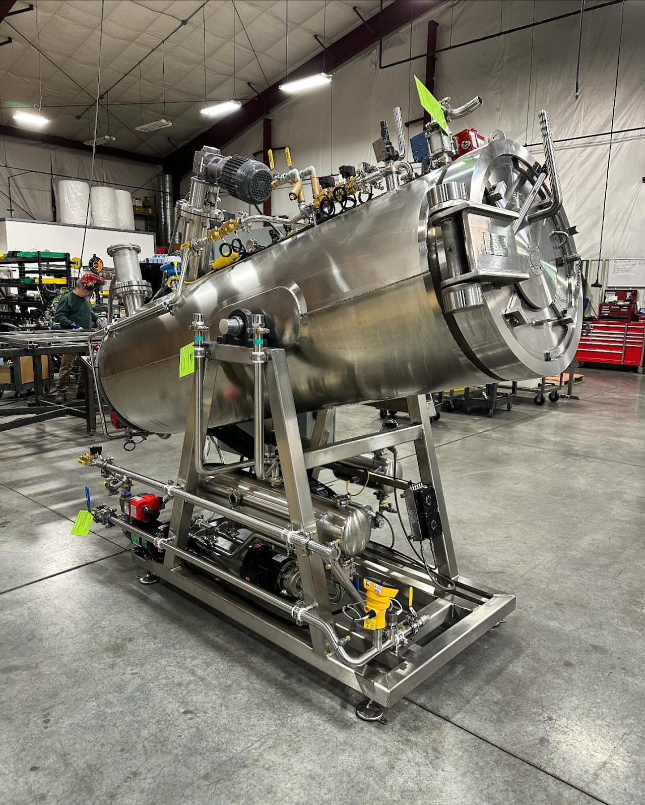 A big metal cylinder tilted on a stand like a telescope