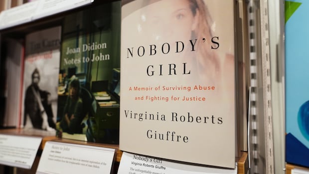A book called Nobody's Girl by Virginia Roberts Giuffre is displayed on a store shelf