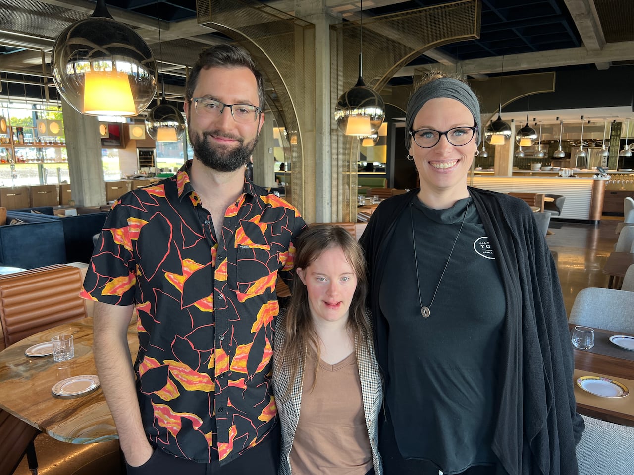 Group of three pose for a picture