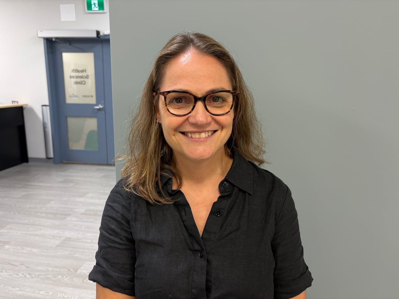 A woman smiles at the camera.