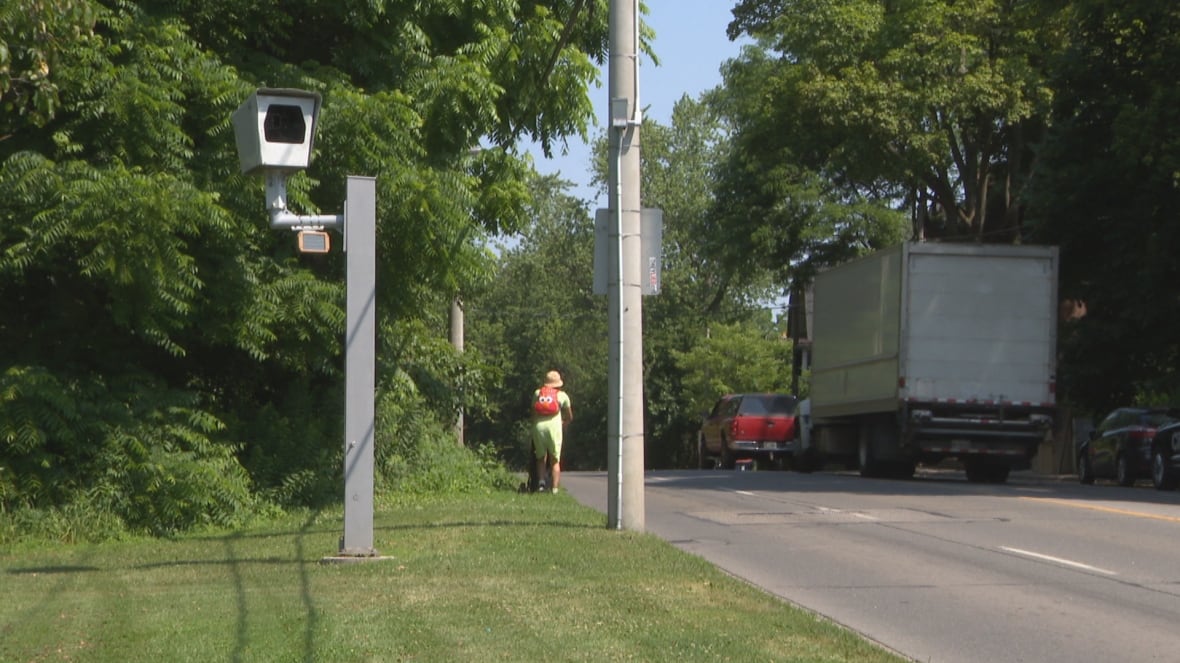 A speed camera is standing on the side of the road on Parkside Drive.