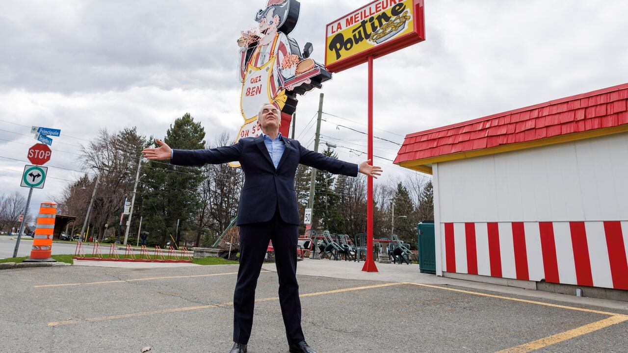 A antheral   stands successful  beforehand   of a motion   astatine  a poutinerie