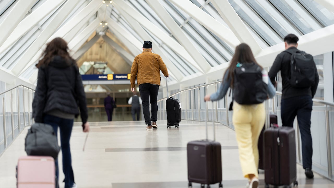 Travelers marque their mode into an airport.