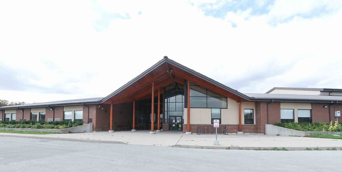 From the front you can see a brick school building.