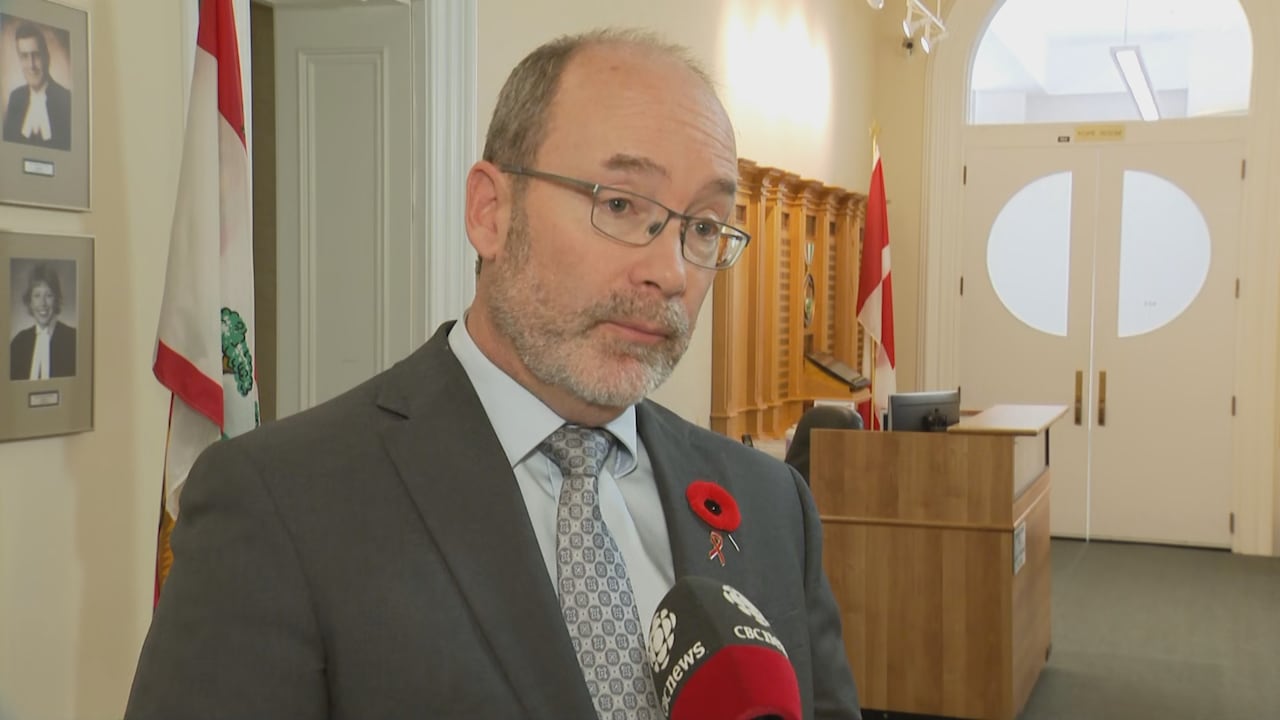 A antheral successful a acheronian grey suit and a achromatic garment lasting astatine the legislature.